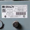 A Brady rating plate label with barcodes on a piece of equipment.