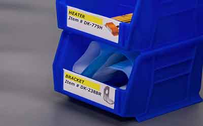 Small plastic storage bins neatly labeled with photos of small hardware parts.