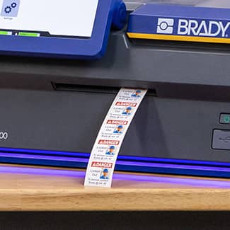 Labels emerging from the J7300 printer with no lead tape demonstrating the printers ability to reduce label waste.