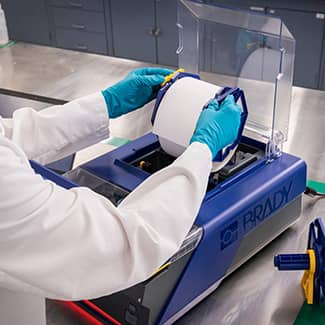 A technical quickly reloading the J7300 printer with new label material.