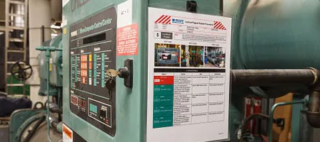 A lockout procedure posted on an industrial manufacturing machine.