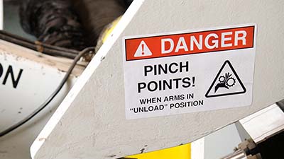 A machine with a label that says 'Danger - pinch points.'
