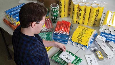 A man assembling safety kits.