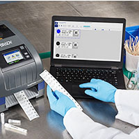 A lab technicial prints labels using Brady Workstation.