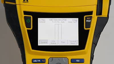 A battery being inserted in the bottom of the M710 printer.