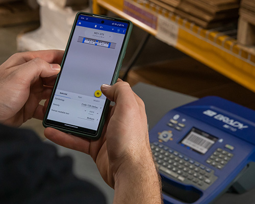 A mobile app is used on a phone to print to the M710 label printer.