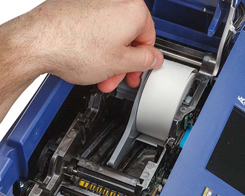 A roll of label material being loaded into a M710 printer.