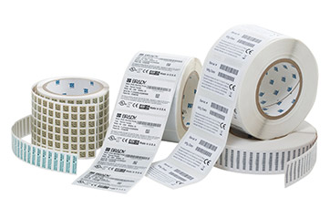 An assortment of rolls of pre-printed custom labels.