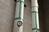 A set of green pipe markers indicate the direction of flow.
