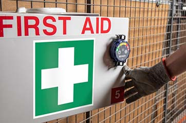 A sign for first aid supplies is in an easy-to-access area.