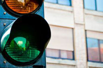A close up of the green portion of a traffic light.