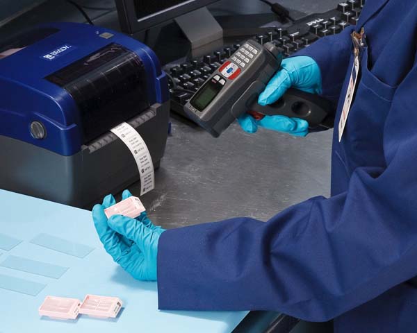 A scientist employing a scanner to verify the ID number of a sample, ensuring accurate tracking and data management.
