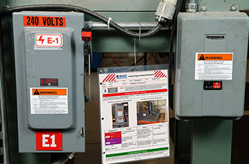 An electrical box with a laminated procedure checklist fixed to it.
