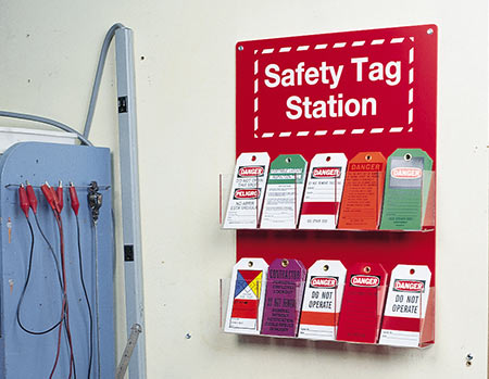 Image of a Safety Tag Station on a wall with many tags in it