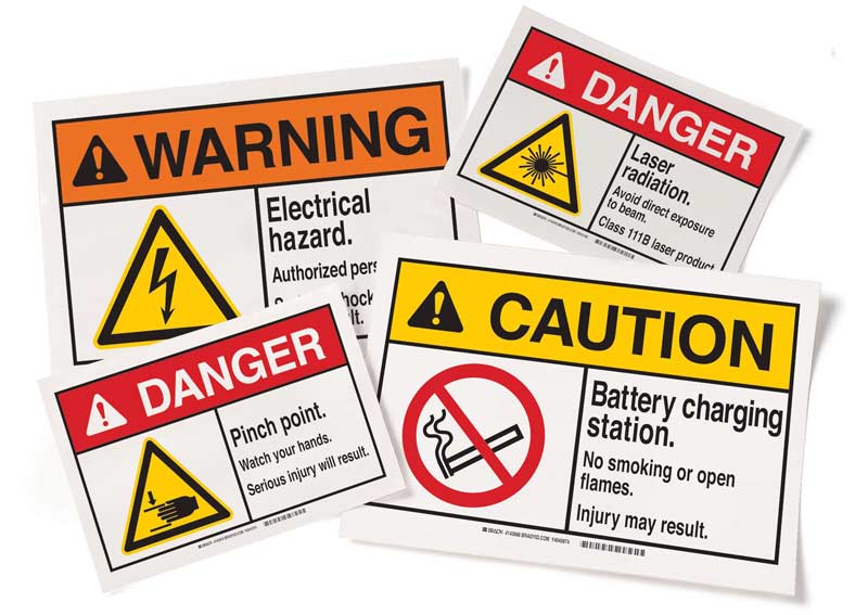 Four different ANSI warning, caution and danger signs are shown for different workplace risks.