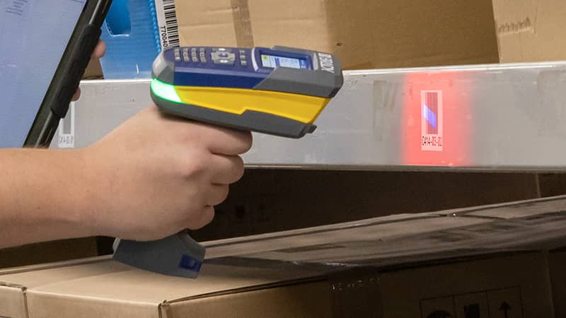 A hand-held RFID reader being used to verify product locations within a warehouse.