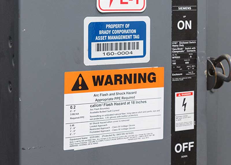 An arc flash tag is shown on an electrical box.