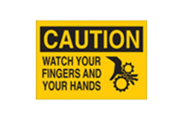 A yellow sign that says "CAUTION WATCH YOUR FINGERS AND HANDS."