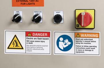 Danger and warning signs on an industrial machine.