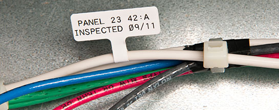 Multiple wires with different colors. White wire has a label that reads Panel 23 42:A Inspected 09/11