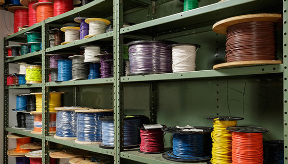 Shelving with many spools of wires in different colors