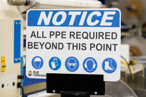 An example of an instructional sign. It reads 'Notice: all PPE required beyond this point'