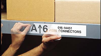 A label is being cleanly peeled from a warehouse rack.