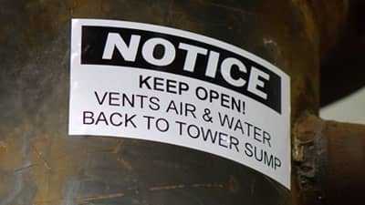 A NOTICE label applied to a ventilation tube warning to keep the vents open for safety.