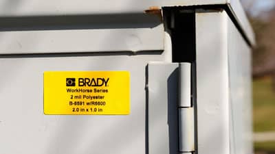 A Brady all-weather polyester label applied to a piece of outdoor equipment.