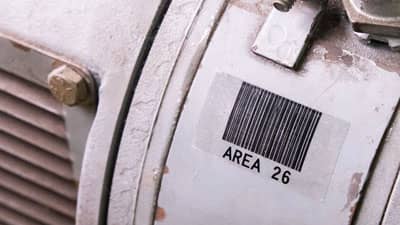 A Brady aggressive adhesive clear label applied to a piece of industrial equipment.