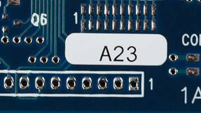 A circuit board with a Brady ESD label applied that is designed to endure the high temperatures of both reflow and non-reflow processes.