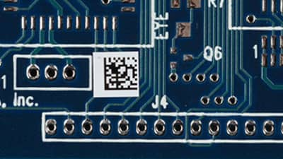 A circuit board with a Brady ultra-thin ESD label applied that is designed to endure the high temperatures of both reflow and non-reflow processes.