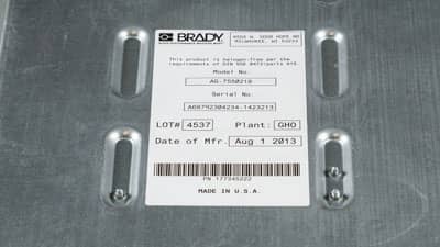 A Brady paper label applied to a piece of electronic equipment identifying its serial and lot number.