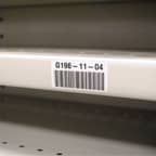 An asset tracking label applied to a shelf.