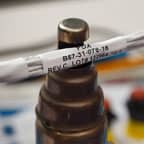 A close-up of a Brady hi-temperature label, with text 