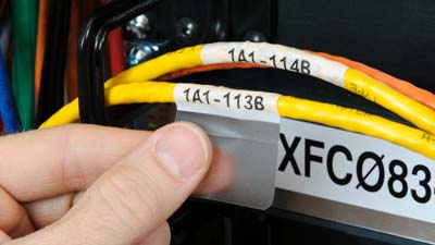 A self laminating label identifying the id of a yellow cable within a cable bundle.