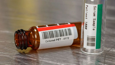 Vials labeled with barcodes and strips of color for quick identification.