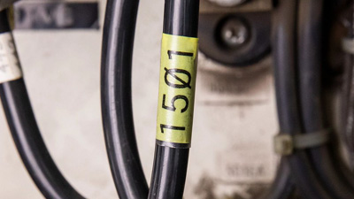 A wrap-around vinyl label indentifying a wire.