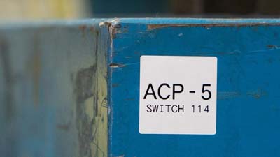 A white label on a piece of equipment, reading 