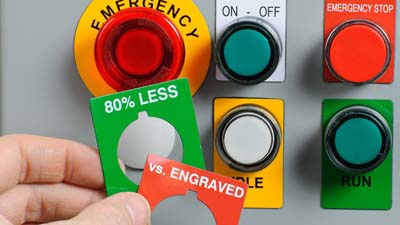 A variety of Brady raised panel labels in different shapes and colors applied to the buttons of a control box.