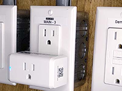 Labels on electrical outlets and devices.