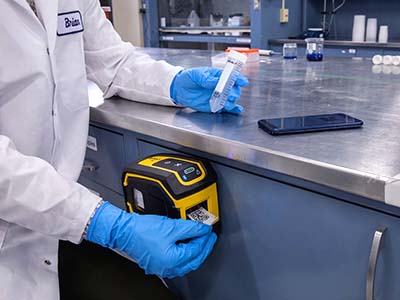 An M211 label printer is conveniently attached to a laboratory work station.