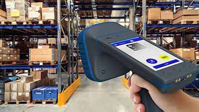 A person using a barcode scanner in a warehouse.